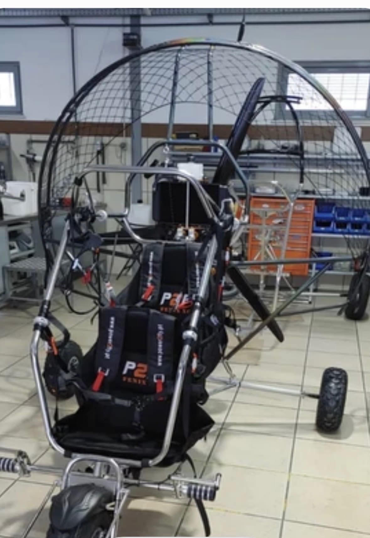The Power2Fly Fenix trike — a seated, wheeled paramotor.